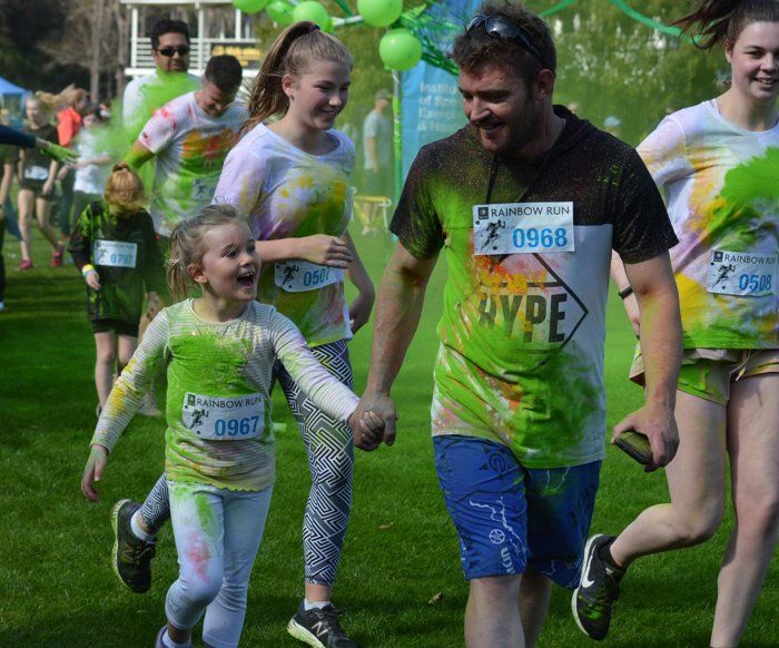 Children and an adult running at the rainbow run.