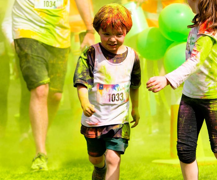 Child running at the Rainbow Run.